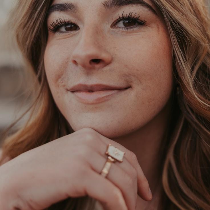 Avery Lin, Lead Design Curator at Dune Cliff Shale, reviewing corporate floral arrangements